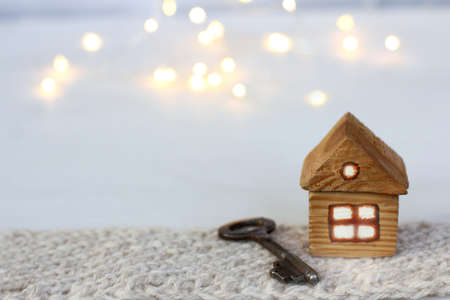 installation from home with a key and a knitted scarf on a background of blurry lights. cozy winter breakの写真素材