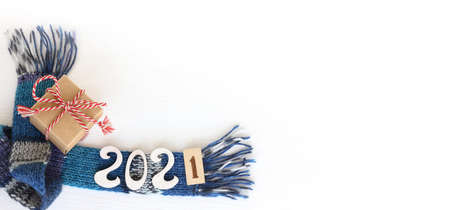 gift and number 2021 on a blue scarf on a table top view. warm new year holidaysの写真素材