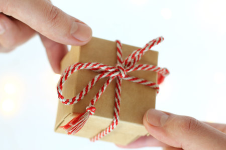 small gift in hands close-up front view. holiday greetings
