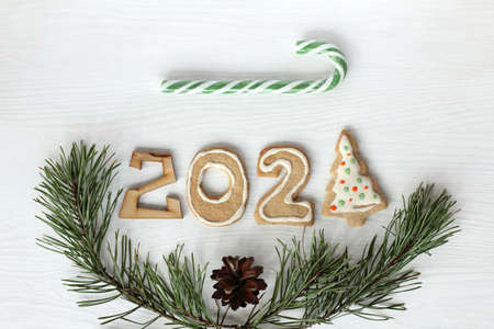 flat lay, gingerbread number 2021 with pine branches and striped candy staff. new year festive screensaverの写真素材