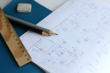 ruler and pencils on an open physics notebook. difficult taskの写真素材
