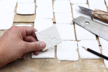 element of decorative tiles in the hand of a worker. decoration works