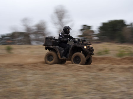 quadracycle at high speed with blurred backgroundの写真素材