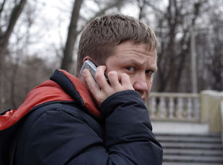 phone speaking man is looking around. May be he is spy?の写真素材