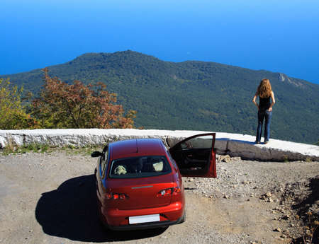 Freedom. Girl looking at the sea. Her car is nearの写真素材