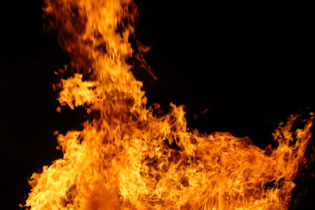 fire background with the tongues of flame at the night 