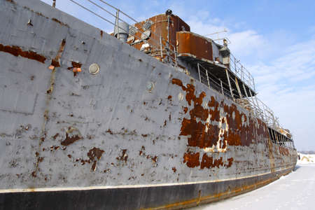 abandoned ship moored at frozen wharfの写真素材
