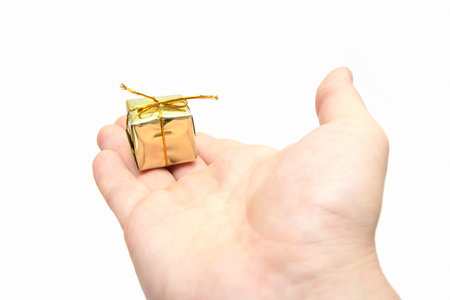 man hand giving a small but expensive gift. Wide angle
