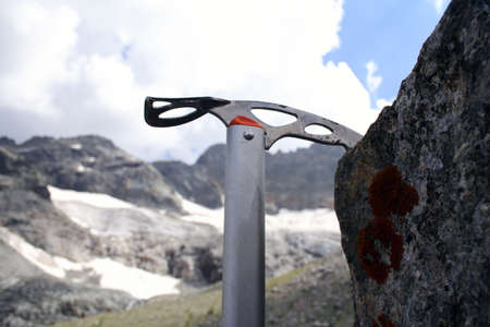 catching on the rock with ice-axe. Blurred mountain ridge at the distance
の写真素材