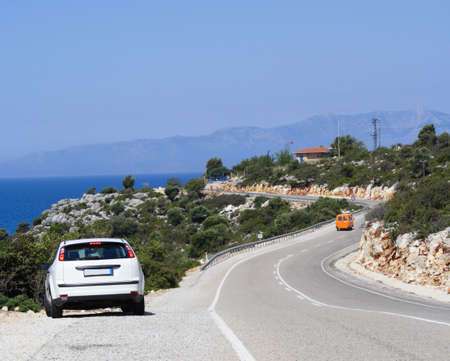 alone car on a sunny road at sea coastlineの写真素材