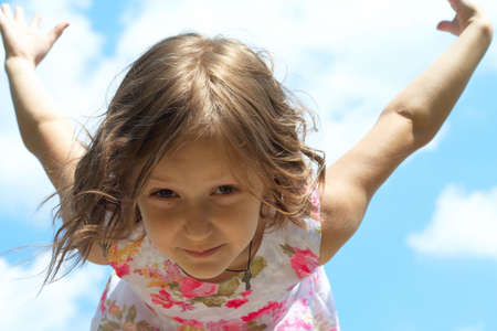 young girl spreading her wings just like bird learning to flyの写真素材