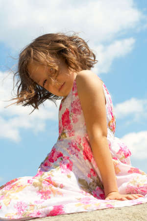 portrait of young beautiful girl at the dress with flowersの写真素材