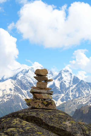 pyramid of stones and mountains with blue cloudy sky in the backgroundの写真素材