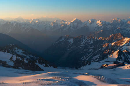 snowed mountains at the sunrise timeの写真素材