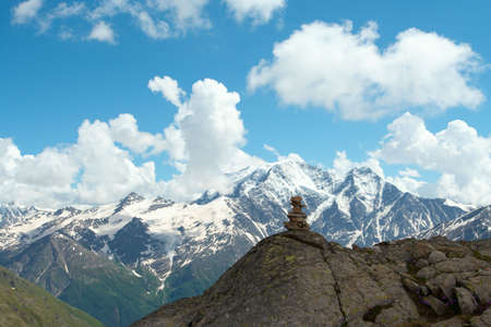 pyramid of stones and mountains with blue cloudy sky in the backgroundの写真素材