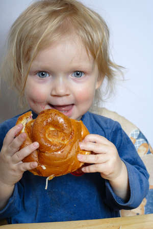 little girl eating a bunの写真素材
