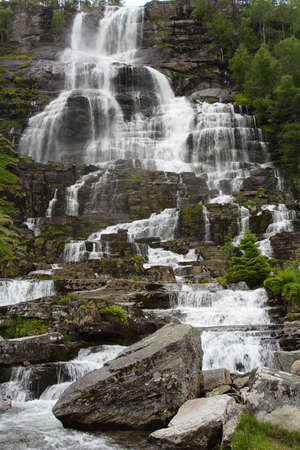 large cascade waterfall in the summer woods, norwayの写真素材