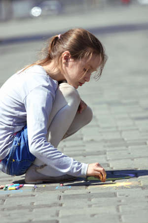 girl  drawing on the asphaltの写真素材