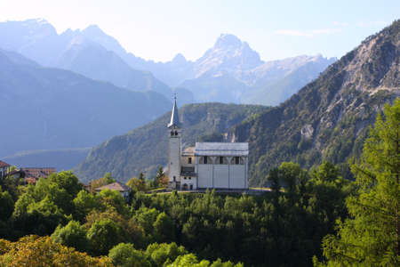 mountain village with the church at the Alps の写真素材