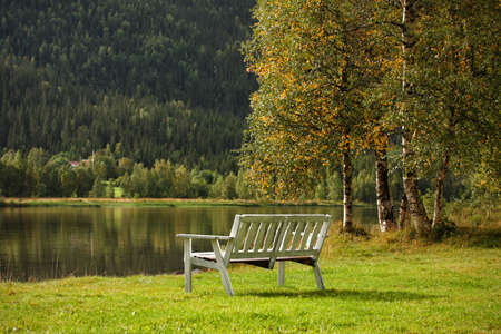 bench on a lake coast in norwayの写真素材
