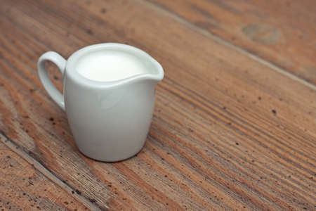 milk jug  on a wooden deskの写真素材