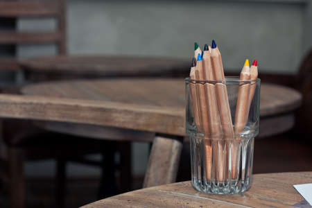 several multicolored pencils on a wooden deskの写真素材