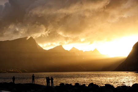 bloody sunset over the sea and mountains peaksの写真素材
