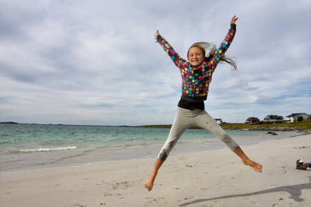jumping girl  with blue sky in the background
の写真素材
