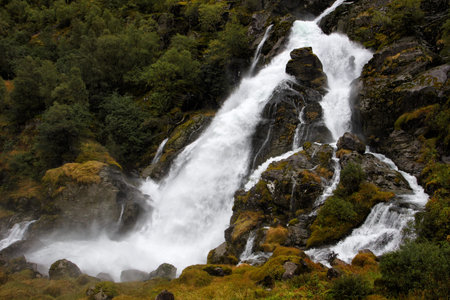 waterfall in the autumn woods, Briksdalen, norway