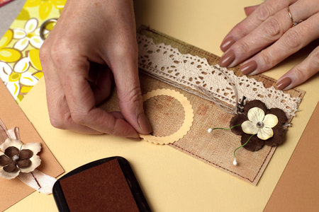 hand made scrapbooking post card and tools lying on a table