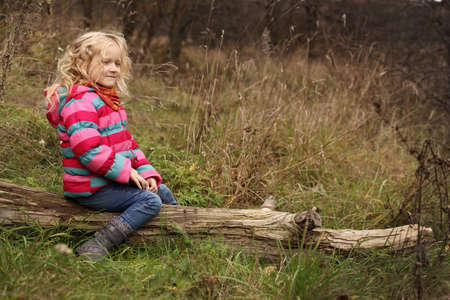 little girl sitting on a stump at the forest
の写真素材