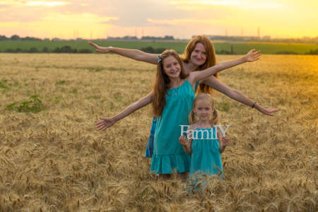 mother with daughters outdoors 
の写真素材