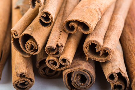 several cinnamon sticks on a white background