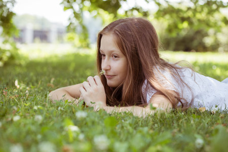 teenager lies on a grass at the parkの写真素材