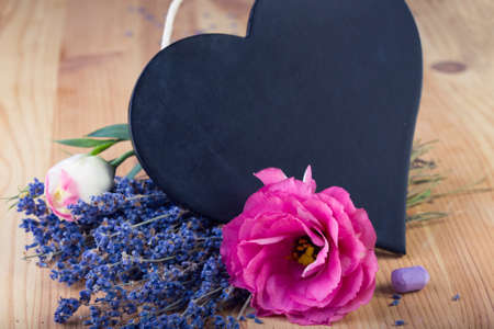 board as heart shape for records with flowersの写真素材