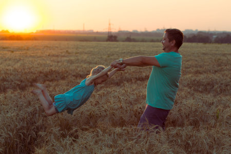 daddy with daughter at the fieldの写真素材