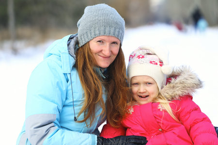 mother and daughter in winter outdoorsの写真素材