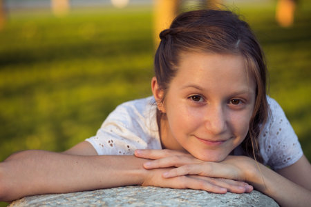 portrait of young smiling girl outdoorsの写真素材