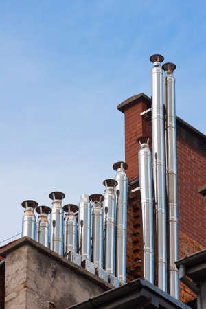 chimney pipes on a residential buildings roofsの写真素材