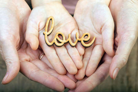 hands holding word loveの写真素材