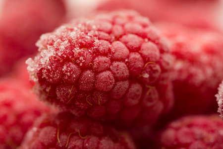 background made of frozen raspberries close upの写真素材