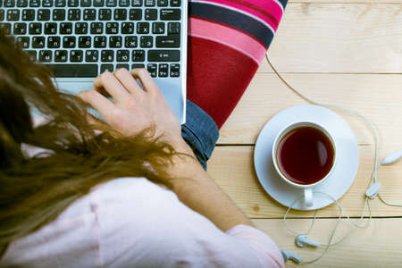 Teen girl sitting with a laptopの写真素材