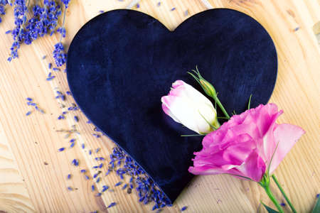 board as heart shape for records with flowersの写真素材