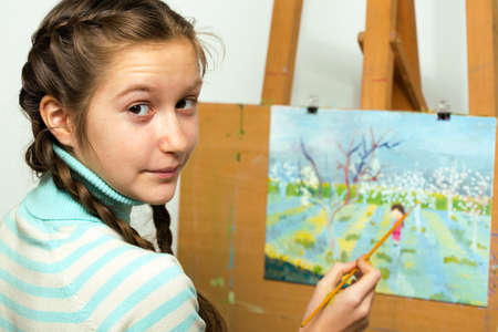 girl artist writes oil paintingの写真素材