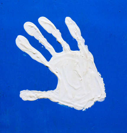 white paints children fingerprints  on a multicolored backgroundの写真素材