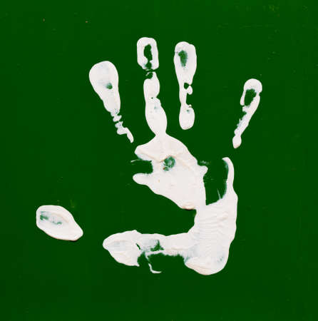 white paints children fingerprints  on a multicolored backgroundの写真素材