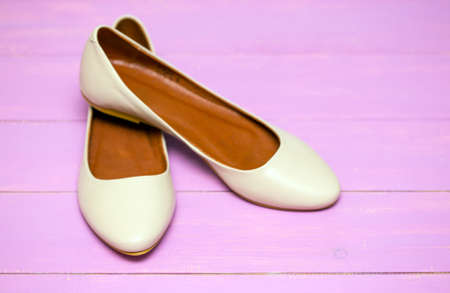 beige shoes on a pink backgroundの写真素材