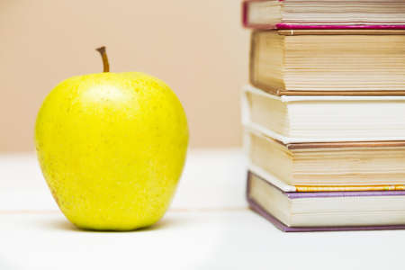 stack of books and apple closeupの写真素材