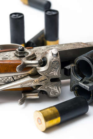 trigger of old-fashioned classic style rifle made of silver with ammunition on a white backgroundの写真素材