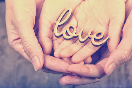 hands holding word loveの写真素材